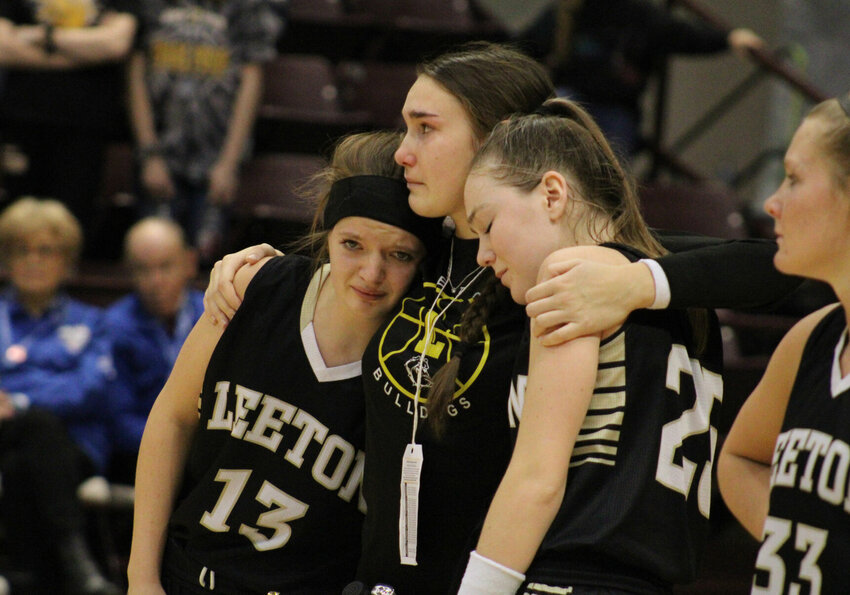 Leeton senior Jordan Crooks, center, comforts sophomore Jillian Mudd and junior Chezney Early following a loss to Platte Valley in the MSHSAA Class 1 third-place game Friday, March 10 inside the Hammons Student Center in Springfield.