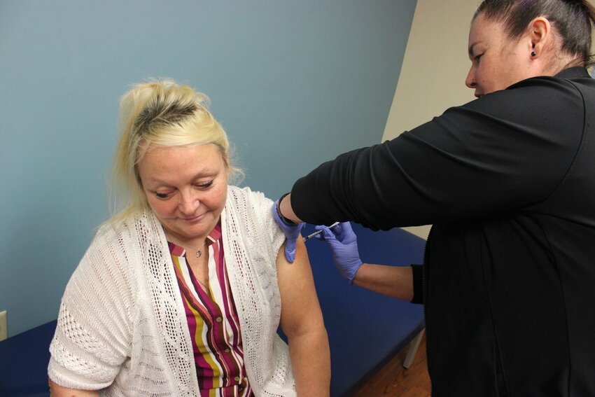 Public Health Nurse Manager Shannon Perez shows how a flu vaccine is administered at Johnson County Community Health Services, 723 PCA Road in Warrensburg.