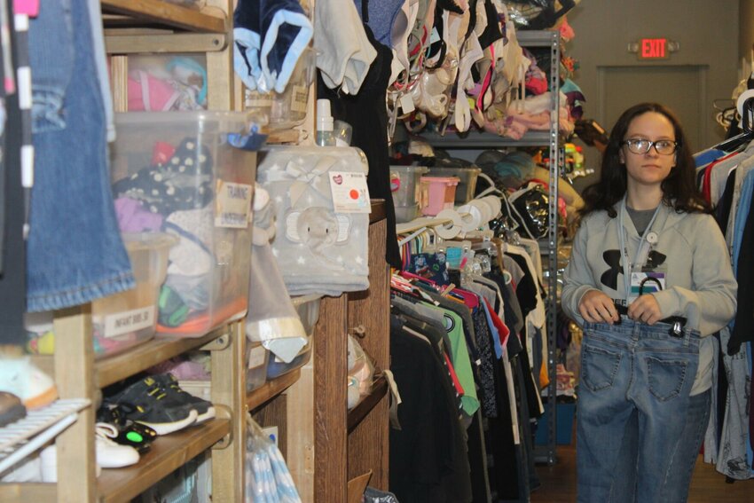 Employee Melodi Marley organizes clothing racks at&nbsp;RISE Racks Thrift Store, 1125 N. Simpson Drive Suite K, on Wednesday, Feb. 7. RISE Racks is set to move into its new space, 125 N. Holden St. in downtown Warrensburg, on May 1.