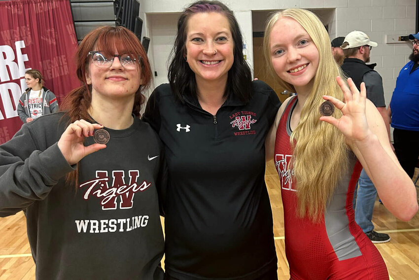 Warrensburg junior Avah Hall, head coach Shelby McDonald and sophomore Cerissa Holsey pose for a photo Saturday, Feb. 10, at Nevada High School. Hall and Holsey both earned qualifications for the MSSHAA Championshis.