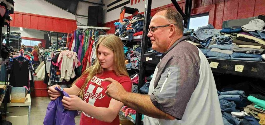Claira Mannering, Warrensburg Middle School eighth grader and Navigators&rsquo; Group member, and Doug Conley, WMS Student Services Coordinator, inventory clothes at Tiger&rsquo;s Den. Warrensburg students and their families can get clothing, school supplies, snacks and other items for free from the clothing closet. Donations are also accepted anytime.