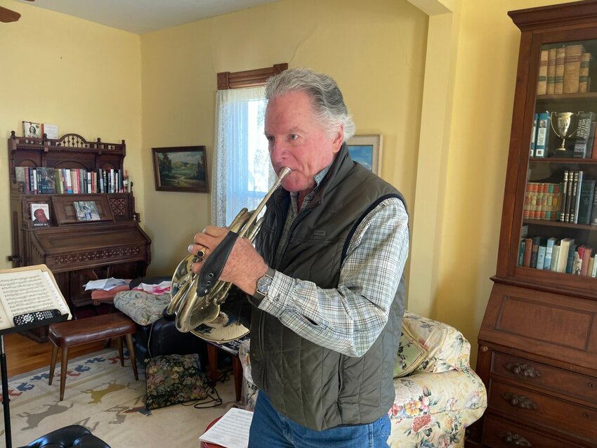 French horn player Bill Lane demonstrates how to play the introduction to the show &ldquo;Little House on the Prairie&rdquo; on Thursday, Feb. 15, in Knob Noster.