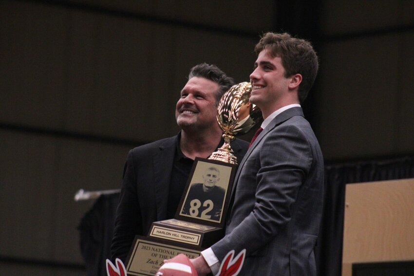 Central Missouri quarterback Zach Zebrowski and Little Rock Touchdown Club represenative David Bazzel pose for a photo with the Harlon Hill Trophy Friday, Feb. 23, at the Jerry M. Hughes Athletics Center.