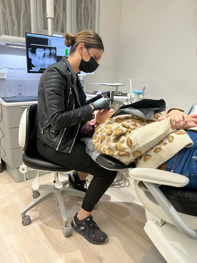 Dr. Rita Garabet does a deep cleaning on patient Lacey Parks, of Warrensburg, after taking x-rays. Garabet initially was looking to see what teeth could be saved before moving onto next steps.   Photo courtesy of Lacey Parks