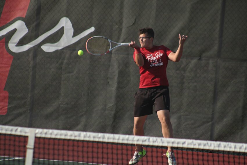 Warrensburg senior Anthony Rehn steps into a swing against Harrisonville on Thursday, March 21, at the Warrensburg Activites Complex.