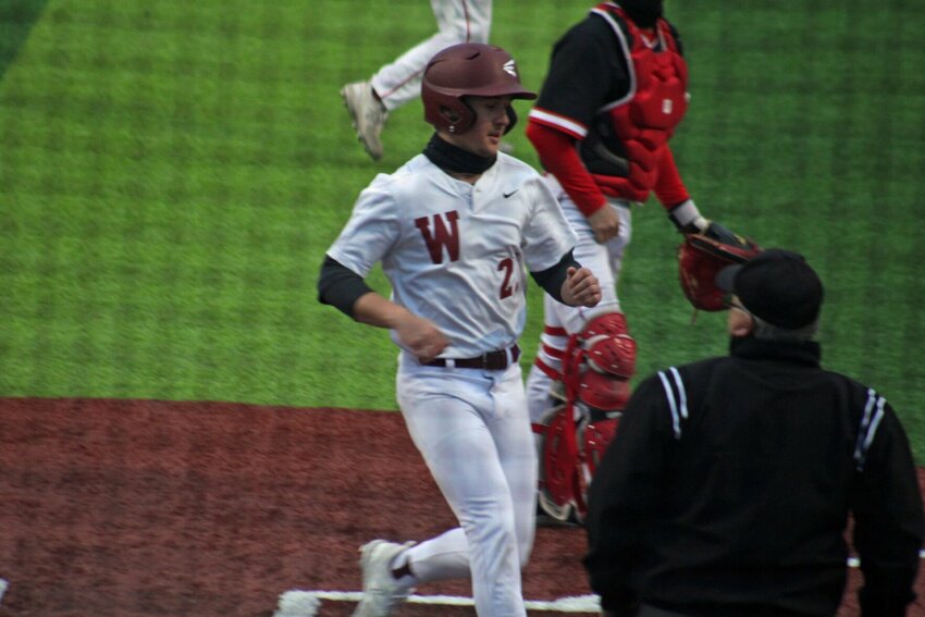 Warrensburg junior Haden Gilpin crosses home plate against Odessa on Tuesday, March 26, at the Warrensburg Activities Complex.