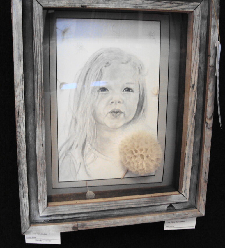 Sande Cromer's &quot;Save the Children&quot; won third in Mixed Media at the 46th Blue Springs Fine Art Show.