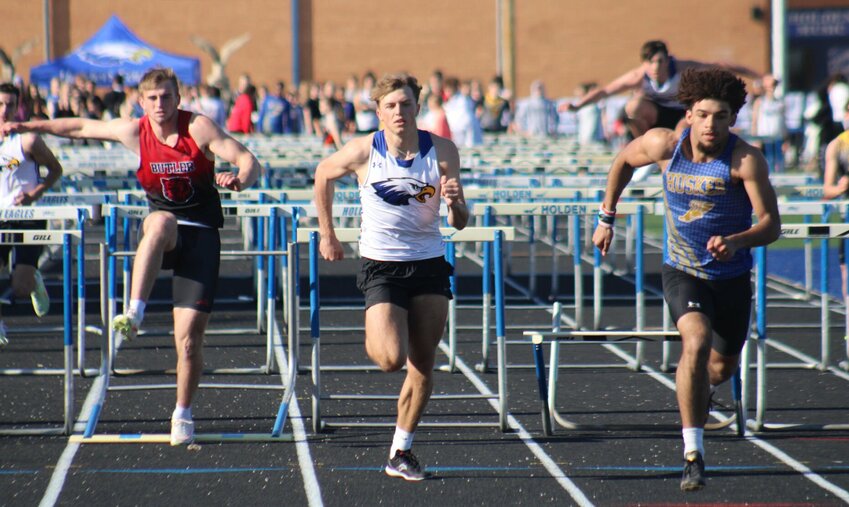 Holden senior Masyn Powell (center) finishes the 110-meter hurdles during the Holden Eagle Invitational on Friday, April 5, at Holden High School.