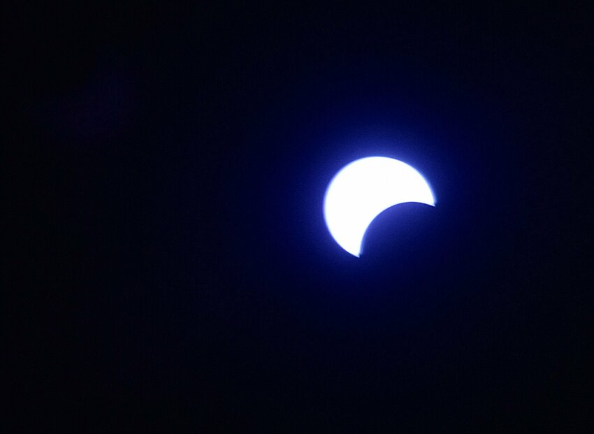 Around 1:20 p.m. Monday, April 8 the moon begins to take a bite out of the sun during the total solar eclipse. Although portions of southeast Missouri saw totality, in Sedalia the eclipse was rated as 93.7%. The last total solar eclipse was in 2017 and its path of totality ran across Sedalia.   Photo by Faith Bemiss-McKinney and Jeff McKinney | Democrat