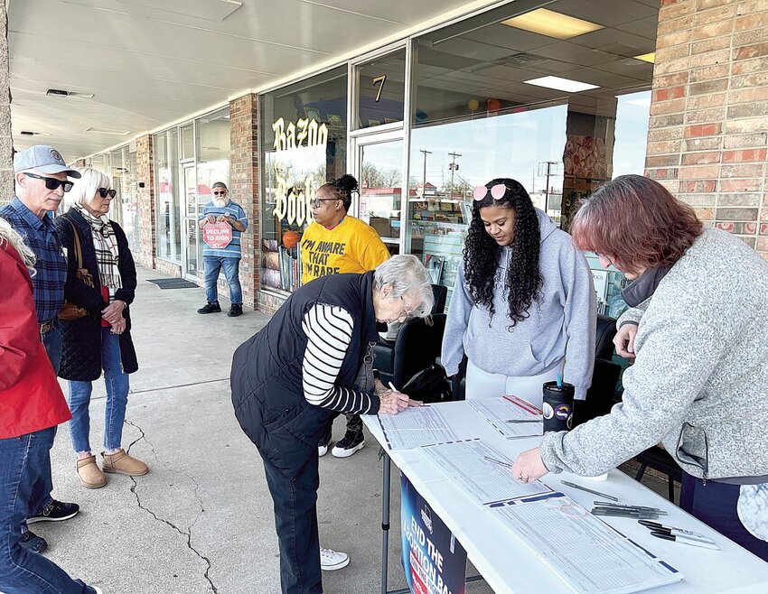 From left, Kourtney Woodbury, of Kansas City, with the Missourians for Constitutional Freedom; Heather Carlos, of Overland Park, Kansas, with Planned Parenthood; and volunteer Teresa Cicela, of Henry County, take signatures for the &quot;Right to Reproductive Freedom Initiative&quot; petition on Friday, April 5, outside Bazoo Books in Sedalia.   Photo by Faith Bemiss-McKinney | Sedalia Democrat