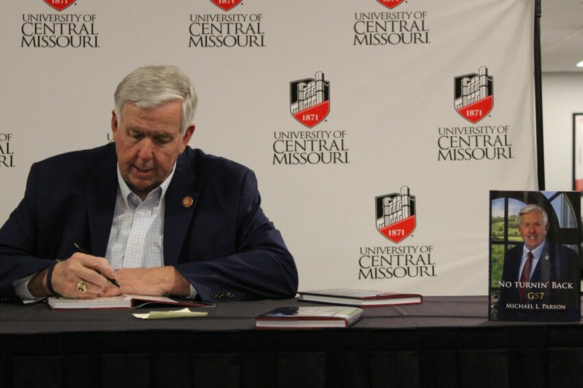 Gov. Mike Parson signs the first of many copies of his new biography &ldquo;No Turnin&rsquo; Back - G57&rdquo; on Monday, April 8, at the Elliot Student Union at the University of Central Missouri.