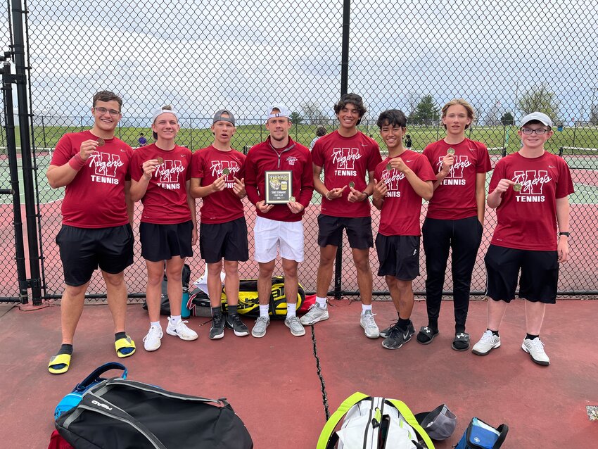 Warrensburg boys tennis poses for a photo with it hardware from the Excelsior Springs Tiger Classic on Wednesday, April 10, in Excelsior Springs.
