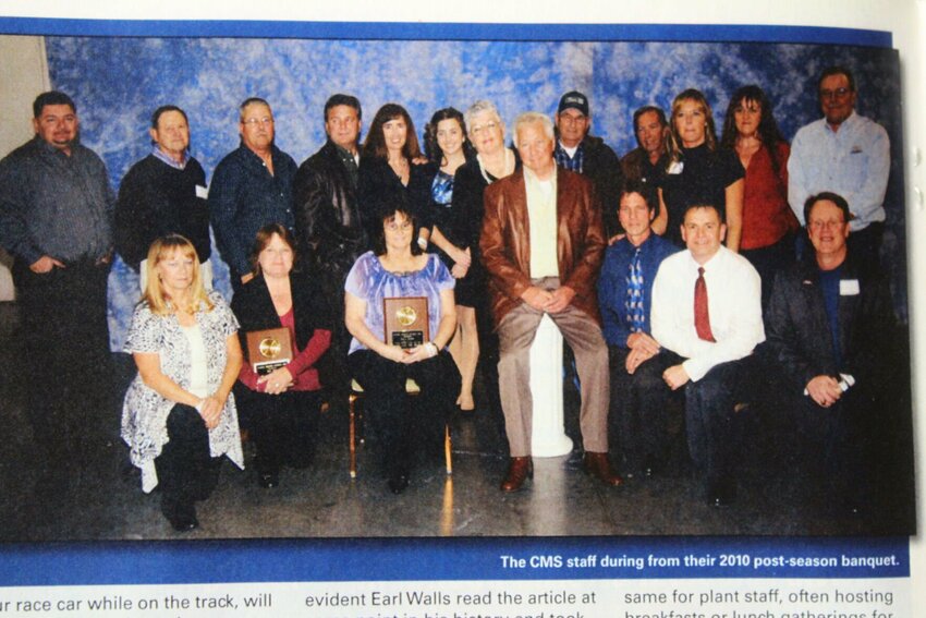 Earl, center wearing a brown jacket, and Susan, center left behind Earl, pose with their staff for a photo in Dirt-Modified Magazine in 2015. The Wallses bought Central Missouri Speedway in 1994, and have worked tirelessly to make it the track it is today 30 years later.&nbsp;
