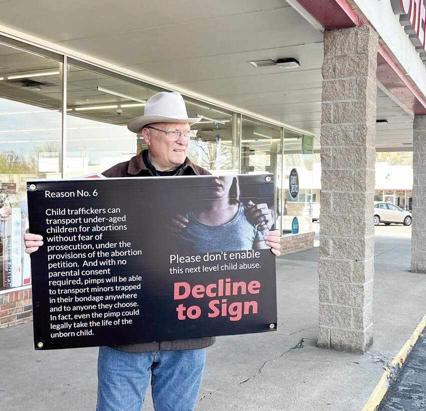 On Friday, April 5, Dan Lowe with the Sedalia Chapter of the Missouri Right to Life holds a sign discouraging petition signers at Bazoo Books. Lowe and several other Right to Life members were on hand for the controversial reproductive freedom petition drive.   File photo by Faith Bemiss-McKinney | Sedalia Democrat