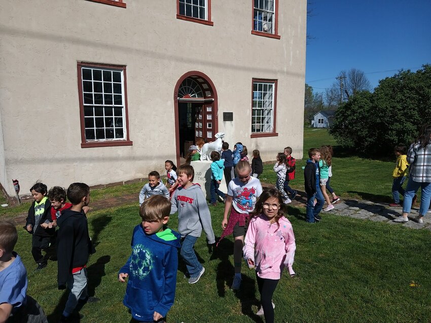 A Ridge View Elementary class heads to the schoolhouse while another class enters the Old Courthouse during a visit to the Johnson County Historical Society on April 11.   Photo courtesy of the Johnson County Historical Society