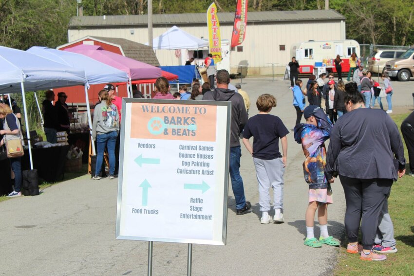 Held back by a leash, a miniature Schnauzer looks toward the front of the festival for other furry friends on Saturday, April 20, at Old Drum Animal Shelter. 