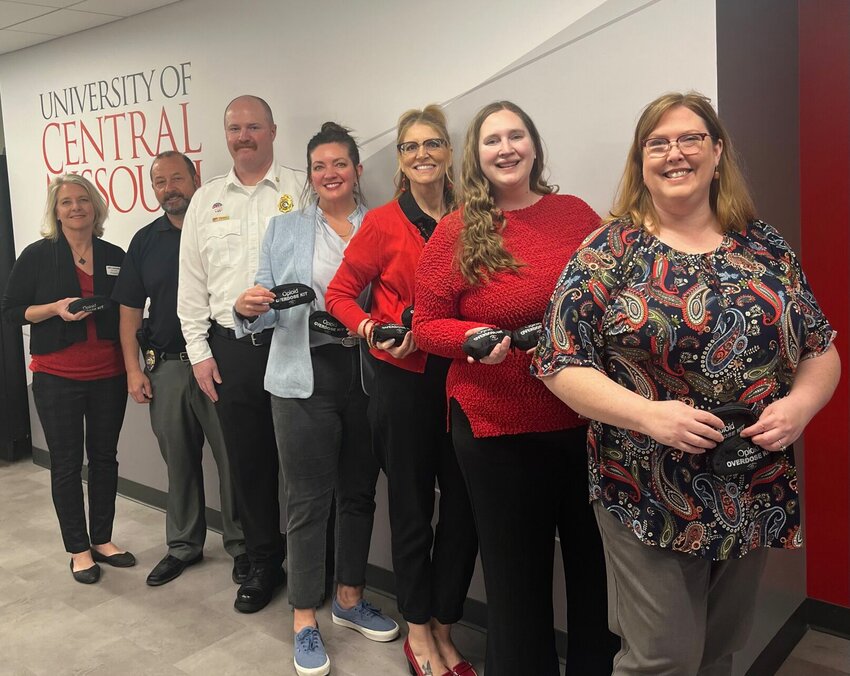 From right, Dr. Amy Kiger, Kourtney Dutton, Dr. Crissy Hall (UCM), City Manager Danielle Dulin, Fire Chief Ken Jennings, Capt. Dan Othic (UCM), and City Clerk Jodi Schneider pose for a picture sporting Naloxone kits.&nbsp;