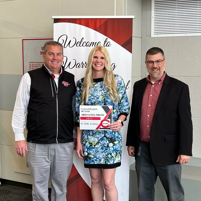 Warrensburg Middle School Principal Holly Jennings, middle, poses for a picture with her Principal of the Year Award and R-VI Assistant Superintendent Dr. John Finnane, left, and R-VI Superintendent Steve Ritter, right.&nbsp;