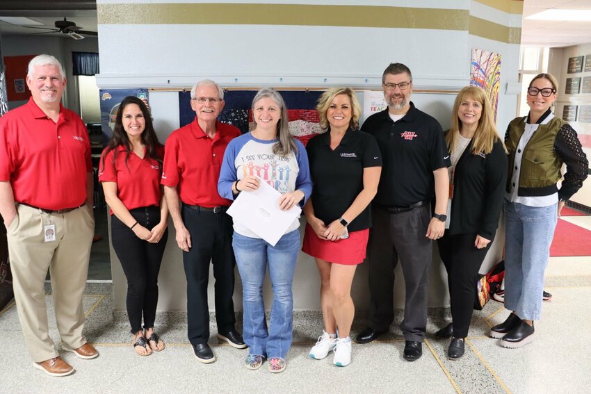 From left, Assistant Superintendent Dr. Troy Marnholtz, Warrensburg Schools Foundation Board Member Catherine Rupp, Foundation Board President Bob Lotspeich, Teacher Scholarship recipient Michelle Carroll, Foundation Assistant Director Dr. Ashlee Holdren, Superintendent Dr. Steve Ritter, Foundation Executive Director Judy Long, and Foundation Board Member Leah Harris.   Photo courtesy of the Warrensburg Schools Foundation