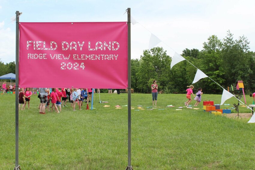 A &quot;Candyland&quot;-inspired sign sticks out of the ground as kids jump from tile to tile on Monday, May 20, at Ridge View Elementary School.&nbsp;The annual Field Day was hosted to celebrate the end of the school year. The last day of school for the Warrensburg School District was Wednesday, May 22.