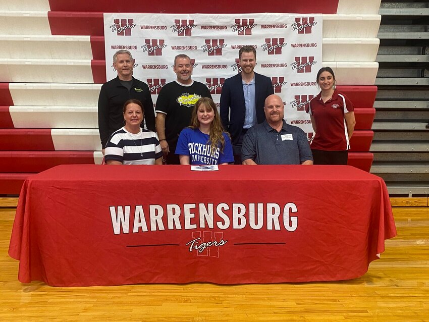 Surrounded by her parents and coaches, Warrensburg senior Isabella Teaford signed her letter of intent to swim at Rockhurst University on Friday, May 17, at Warrensburg High School.