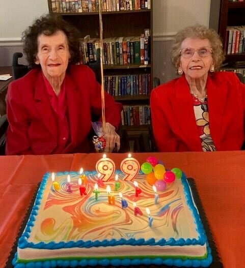 Identical twins Mildred Louise Beard, left, and&nbsp;Virgie Lee Fockler smile for a photo on their 99th birthday on June 4. Born in 1925, the two chose their favorite color red as their celebratory clothes.&nbsp;