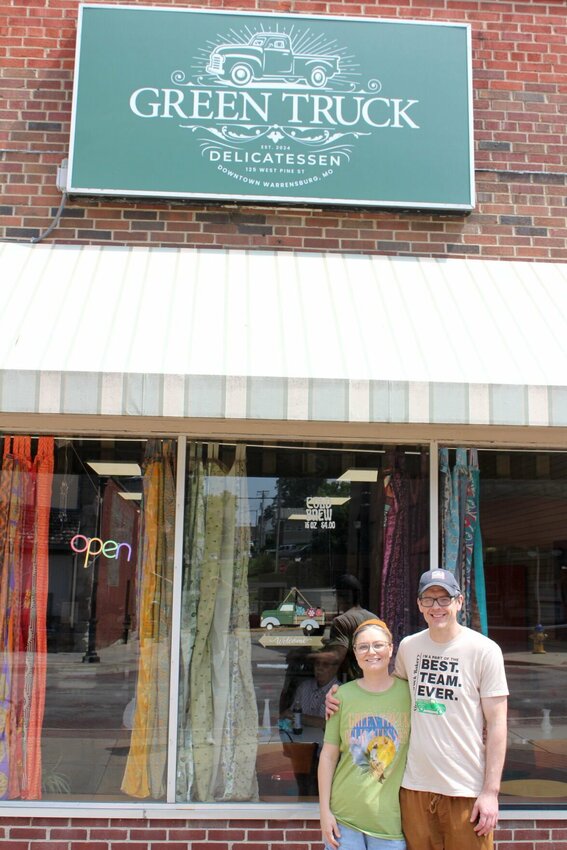 Owners Ryan and Lara Schick stand in front of their business, Green Truck Delicatessen, on Friday, June 21, at 125 W. Pine St.