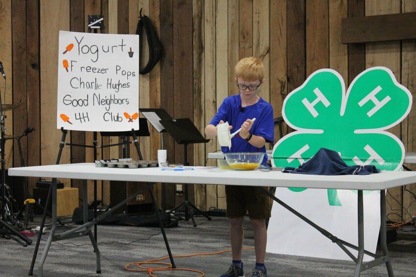 Charlie Hughes demonstrates how to make yogurt freezer pops during the contest portion of the Johnson County Youth Fair on Saturday, June 22, at the JC Cowboy Church.&nbsp;
