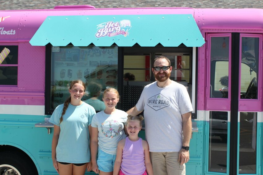 Ice Burg owner Andy Weldon, right, poses for a photo with his three daughters from left Sophia, age 13, Zoey, 10, and Emma, seven on Tuesday, July 2, at the All Stars Preschool/Childcare. 