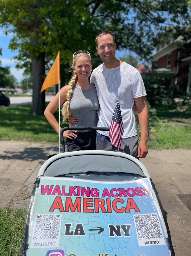 Carolyn Ronning and Robert Malone have been walking across America for the past four months and were found walking down Broadway Boulevard Wednesday. The married couple is due to arrive in New York in October and can be followed and supported in Instagram at OneLifeLet'sGo. Photo by Chris Howell | Sedalia Democrat