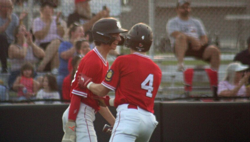 Maverick Martin and Charlie Morgan celebrate runs scored during Mule Club Post 131’s win against Jefferson City Post 5 in the first round of the AA Missouri American Legion State Tournament on Thursday, July 25, at the Warrensburg Activities Complex.