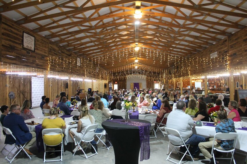 Warrensburg Chamber sponsors and members enjoy a barbecue dinner and listen to the awards ceremony on Thursday, July 25, at the Twin Oaks Event Center.