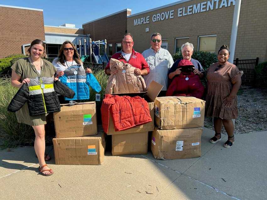 The Jubilee Council of the Knights of Columbus of Warrensburg pose for a photo with staff members at Maple Grove Elementary after donating 72 coats for Warrensburg R-VI School District kids. 