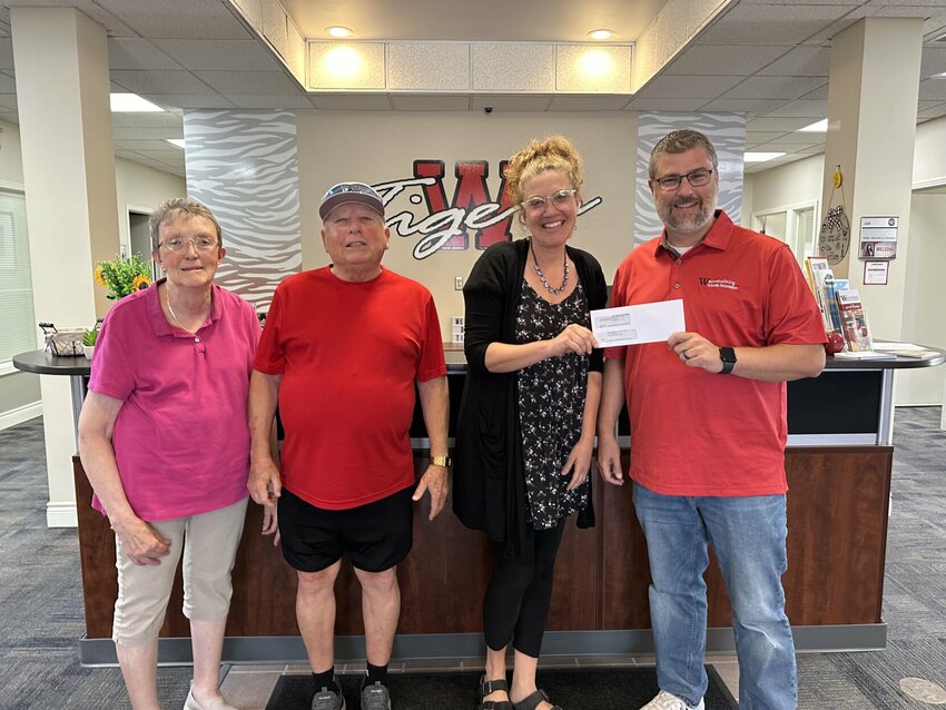First United Methodist Church Pastor Kayla Meredith, middle right, hands a check with proceeds from her &quot;Undy Sunday&quot; drive to Warrensburg R-VI School District Superintendent Steve Ritter, right, on Monday, Sept. 9, at the Warrensburg High School. Also pictured are Ann Lossman, left, and drive leader John Culp, middle left.&nbsp;