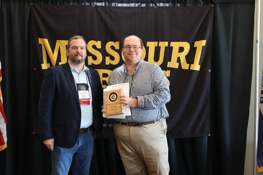 Missouri Press Association President Amos Bridges presents Warrensburg Star-Journal interim Managing Editor Joe Andrews with the publication's nine 2024 MPA Better Newspaper Contest Awards on Saturday, Sept. 21, at the Hotel Vandivort in Springfield. 