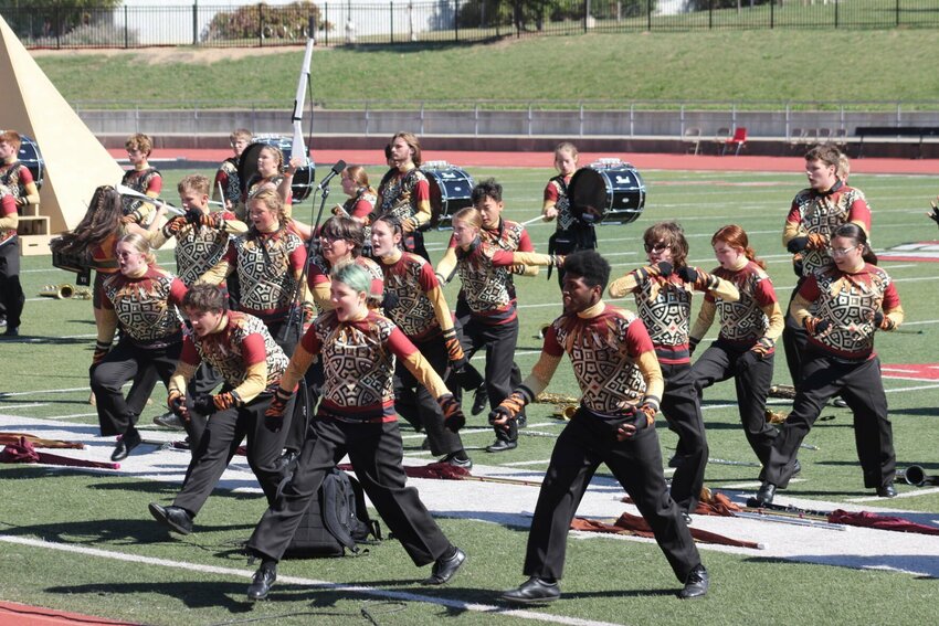 Warrensburg High School marching band members approach the stands during their performance 