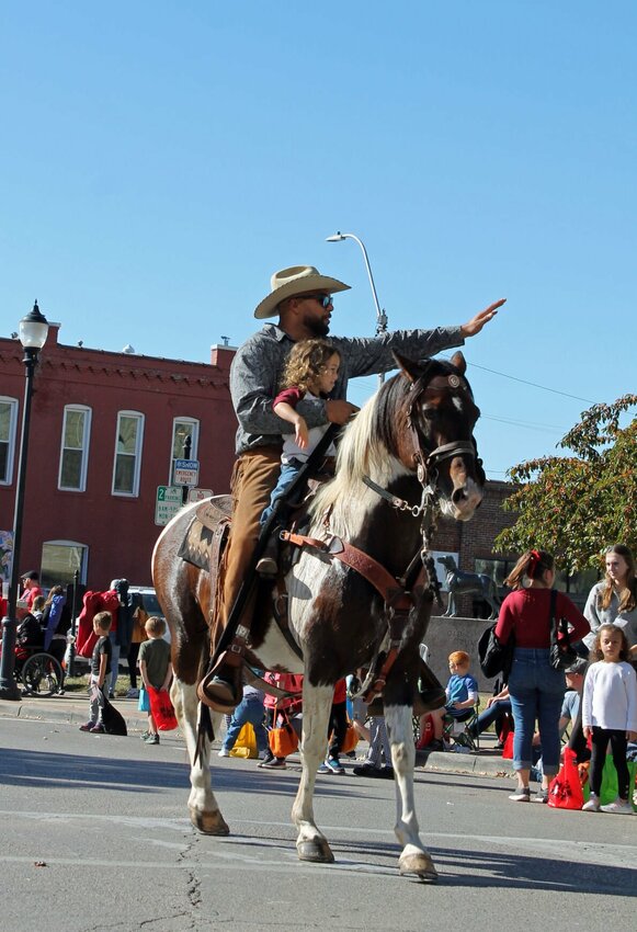 Two riders wave to the crowd as the horses signal the end of the UCM Homecoming parade on Oct. 21, 2023. The 2024 parade will take place at 9 a.m. Saturday, Oct. 26 in Downtown Warrensburg. 


Fille photo by Nicole Cooke | Star-Journal