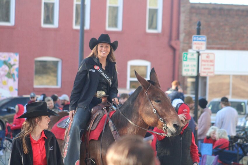 Emma Lock rides Molly the Mule during the Homecoming Parade on Saturday, Oct. 26 in Downtown Warrensburg.