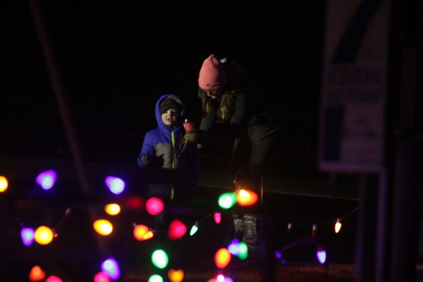 A family walks through the Lions Lake Holiday Trail on Saturday, Nov. 30. Warrensburg Parks and Recreation turned on the lights with a ceremony. The display, which lines the trail at Lions Lake, will be open through the new year.