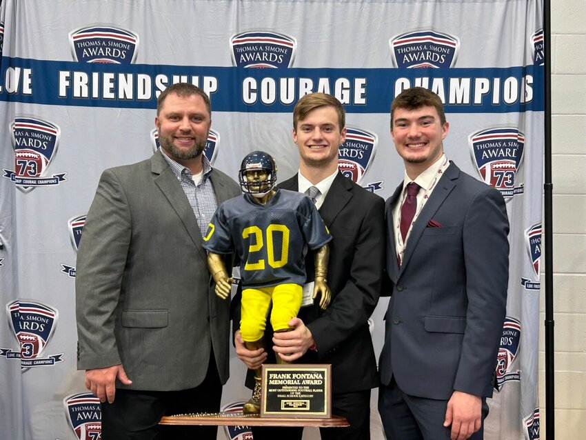 Kobe Westphal took possession of the Frank Fontana Trophy during the Thomas A. Simone Awards on Tuesday, Dec. 10, at Liberty High School. Westphal was also honored as a member of the All-Simone team alongside senior linebacker Ryan Munsterman. From left: Chris Cavanah, Westphal and Munsterman.&nbsp;