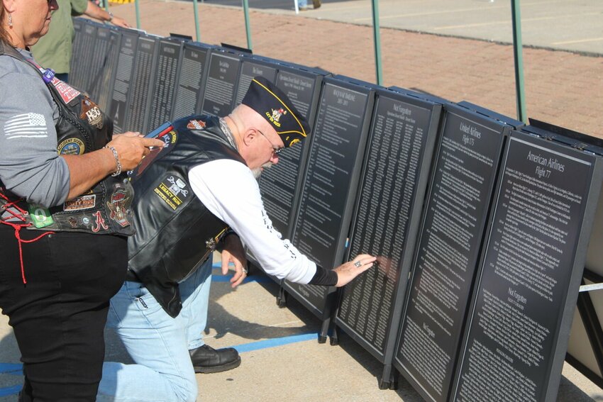 An American Legion Rider feels the name of a loved one lost in Operation Desert Shield on one of the panels on the Cost of Freedom Tribute on Sunday, August 18, at the Missouri Veteran&rsquo;s Home in Warrensburg.