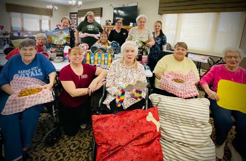 Care center members pose for a photo with their homemade donations to Old Drum Animal Shelter on Tuesday, Jan. 28, at Warrensburg Manor Care Center.