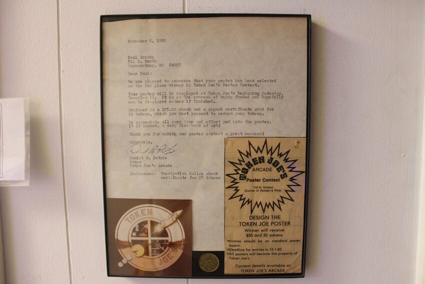A framed letter details a second place winner in a Token Joe's Arcade poster contest on Wednesday, Jan. 29, at the Retrograde Charitable Toy and Videogame Museum in Warrensburg. Token Joe's Arcade was the only videogame arcade in Warrensburg in the 1980s and early 90s.&nbsp;&nbsp;