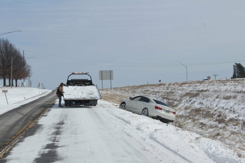 A tow truck helps lift a vehicle stuck in a ditch out on Wednesday, Feb. 19, on Stahl Drive in Warrensburg.&nbsp;