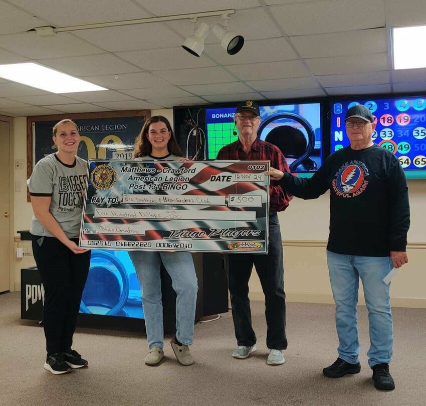From left to right: Johnson County Big Brothers Big Sisters Whiteman Air Force Base board vice president Zoe Dagostino and president Rachel McKinney accept a $500 check from Gerald Seelinger and Steve DelVecchio of the Matthews-Crawford Post No. 131 American Legion.