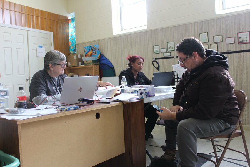 Journey Home Co-Director Mary McCord, left, shuffles through applications to find the right paperwork for a member of the unhoused community on Thursday, Jan. 9, at the First Presbyterian Church in Warrensburg. McCord, along with grant writer Barri Taylor, helped obtain over $70,000 in grants for Journey Home in 2024.&nbsp;