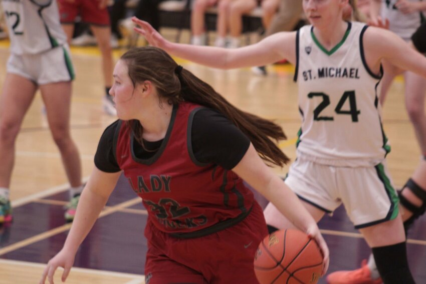 Warrensburg senior Avrie Fox drives the ball against St. Michael the Archangel on Saturday, March 8, at Belton High School.