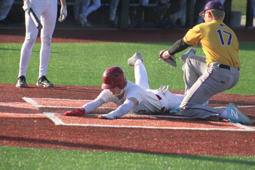 Warensburg senior Jack Smith-Taylor slides into home plate against Belton on Tuesday, April 8, at the Warrensburg Activities Complex.