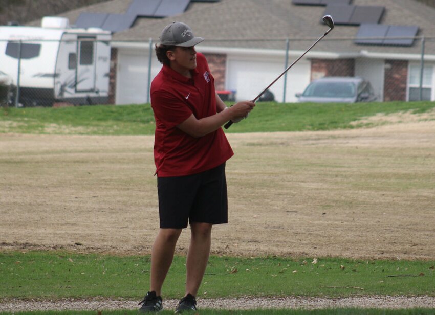 Warrensburg junior Briggs Claunch watches a shot Wednesday, April 9, at the Sandstone Country Club.