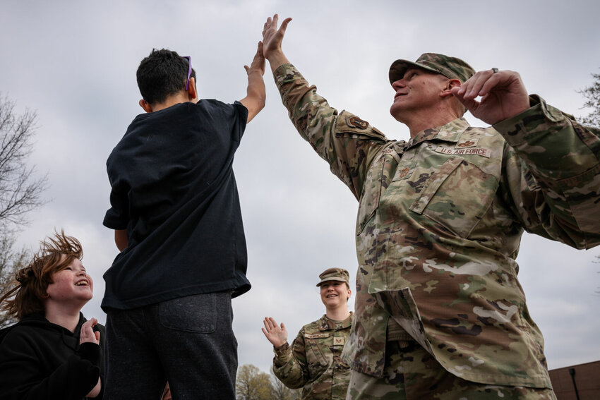 U.S. Air Force Chief Master Sgt. Jeffery Sipos, 509th Bomb Wing command chief, gives a high five to a Whiteman Elementary School student during the Month of the Military Child mile-walk at Whiteman Air Force Base, Missouri, April 11, 2025. Month of the Military Child is observed each April to honor and celebrate military children and youth for their service, commitment and sacrifice in support of the Air Force mission.&nbsp;